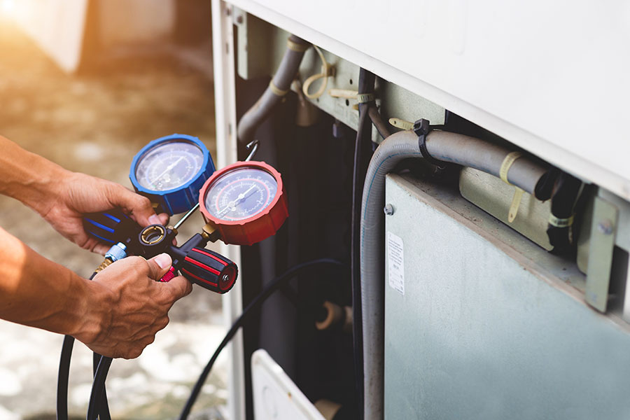 Technician performing AC refrigerant leak repair in Oxford